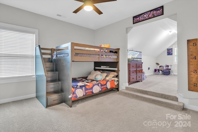 carpeted bedroom with ceiling fan and lofted ceiling