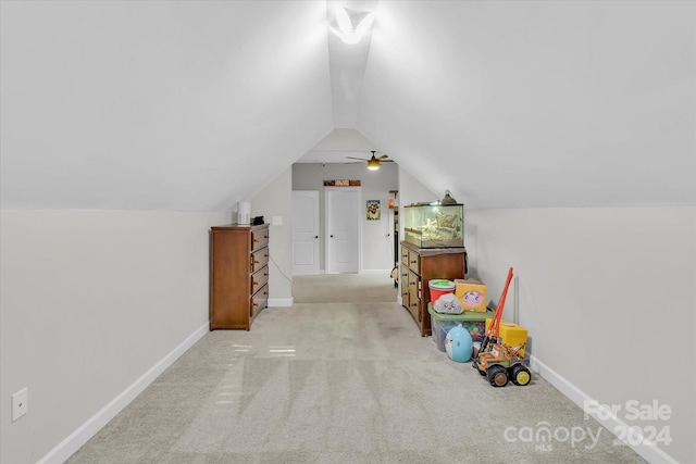 additional living space featuring ceiling fan, light colored carpet, and lofted ceiling