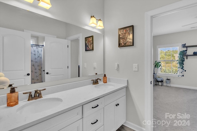 bathroom featuring vanity and curtained shower