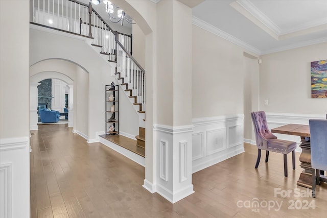 interior space featuring a chandelier, hardwood / wood-style floors, and ornamental molding