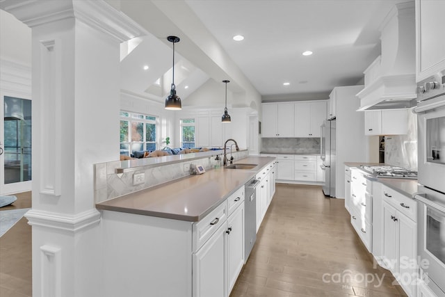 kitchen with white cabinets, decorative backsplash, sink, and appliances with stainless steel finishes