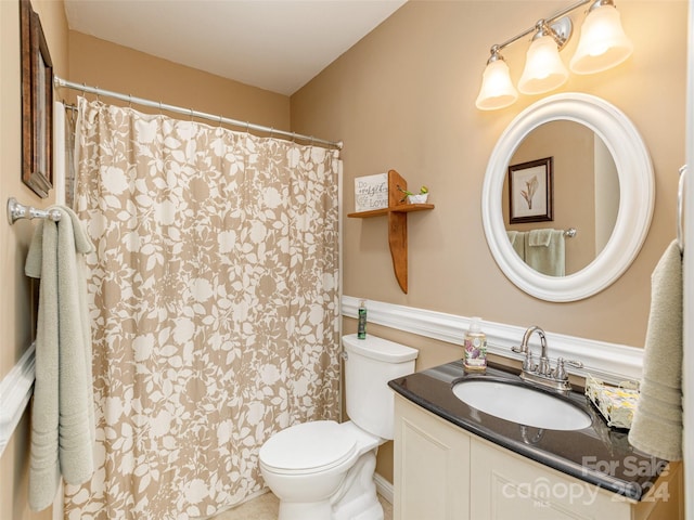 bathroom featuring toilet and vanity