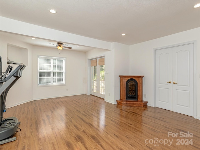 living room featuring ceiling fan and wood-type flooring