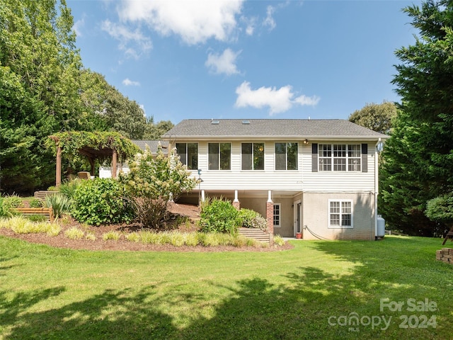 rear view of property with a yard