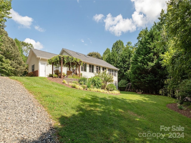 view of property exterior with a lawn and a garage