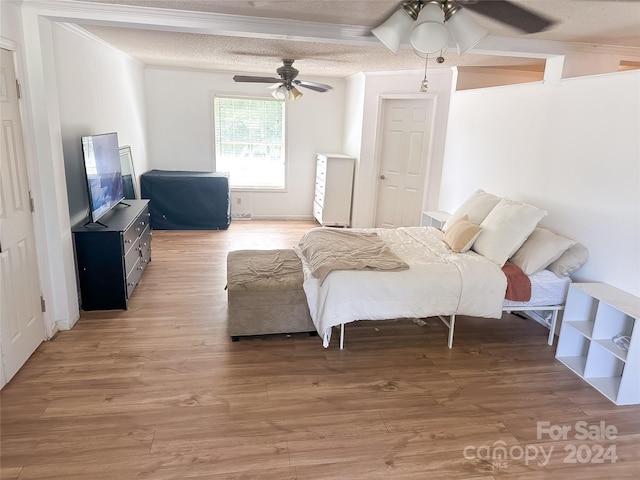 interior space with a textured ceiling, hardwood / wood-style flooring, and ceiling fan