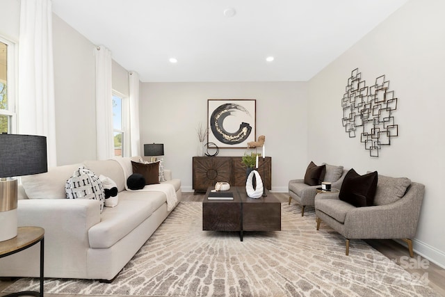 living area featuring recessed lighting and baseboards