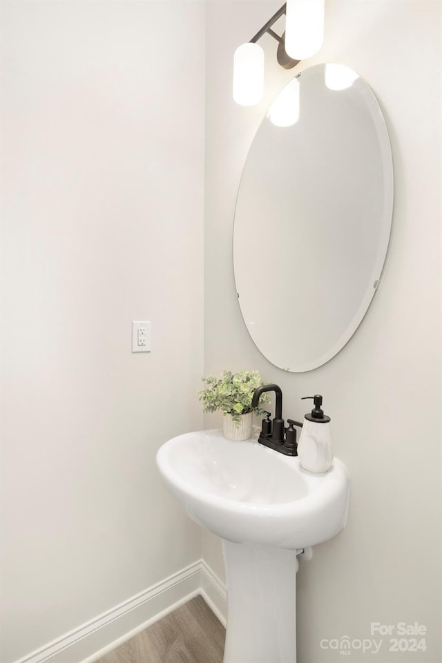 bathroom featuring baseboards and wood finished floors