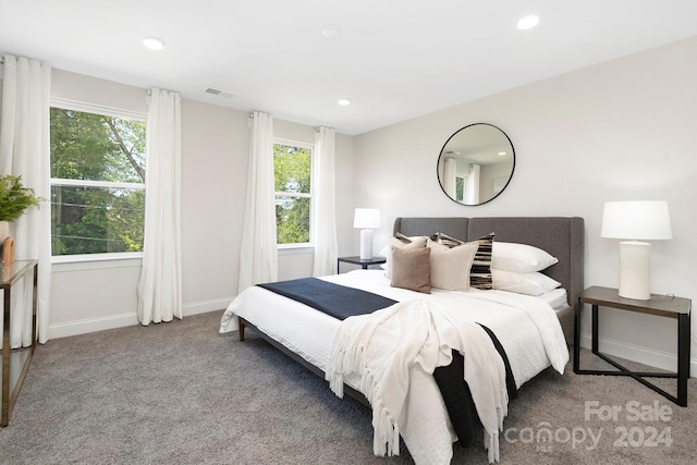 carpeted bedroom featuring visible vents, baseboards, and recessed lighting