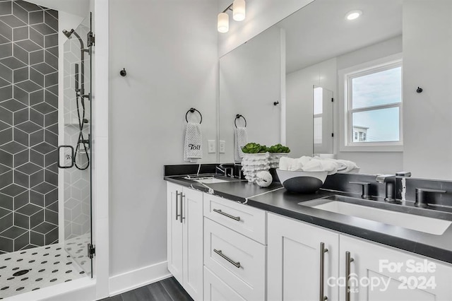 bathroom with hardwood / wood-style floors, vanity, and a shower with shower door