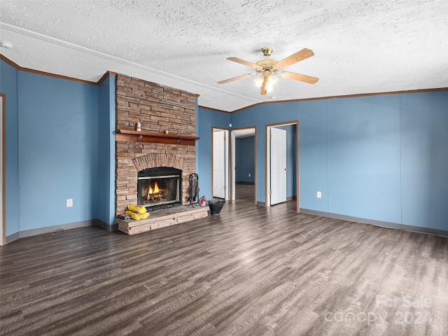 unfurnished living room featuring crown molding, a ceiling fan, a stone fireplace, and wood finished floors