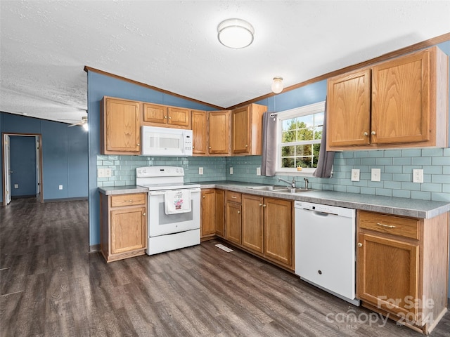 kitchen with dark wood-type flooring, a sink, light countertops, white appliances, and lofted ceiling