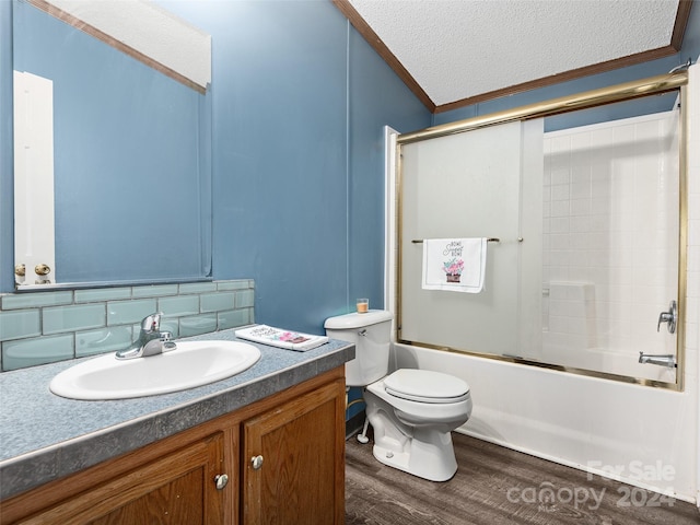 full bathroom featuring combined bath / shower with glass door, toilet, ornamental molding, a textured ceiling, and wood finished floors