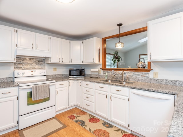 kitchen with lofted ceiling, white appliances, white cabinets, sink, and light wood-type flooring