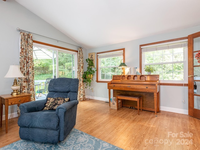 sitting room featuring light wood-type flooring and vaulted ceiling