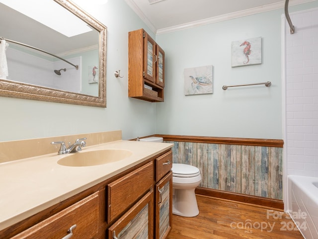 full bathroom featuring crown molding, hardwood / wood-style floors, toilet, wooden walls, and vanity