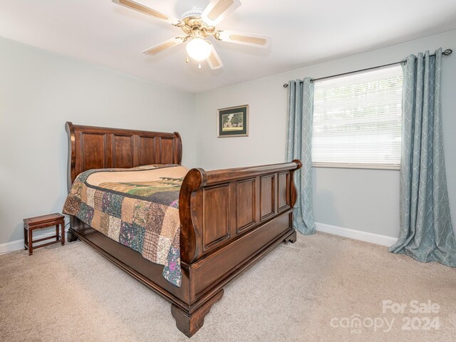 bedroom with ceiling fan and light carpet