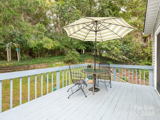 wooden deck with a lawn