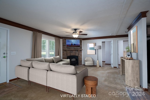 living room featuring ornamental molding, a fireplace, ceiling fan, brick wall, and light colored carpet