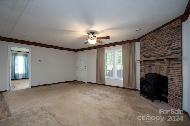 unfurnished living room featuring light colored carpet, ceiling fan, crown molding, and a wood stove