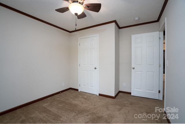 unfurnished bedroom with ceiling fan, carpet floors, and ornamental molding