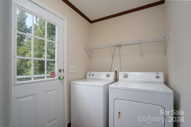 laundry area featuring crown molding and washer and clothes dryer