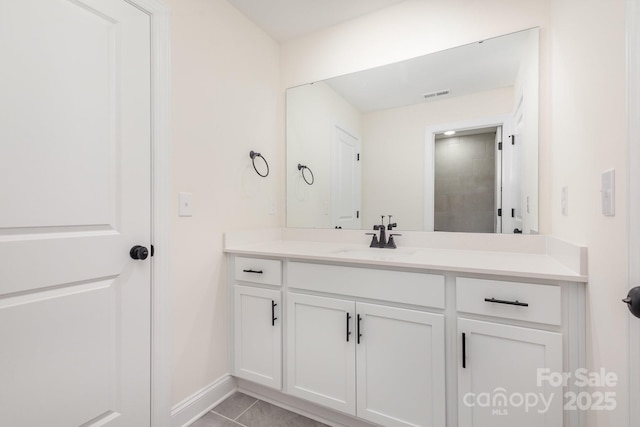 bathroom featuring vanity, tile patterned floors, baseboards, and visible vents