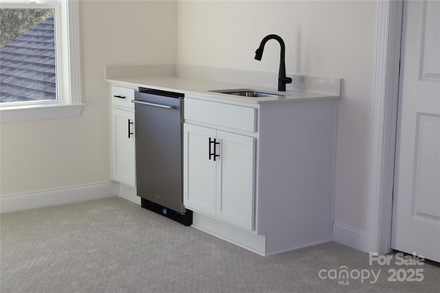 bar featuring light colored carpet, stainless steel dishwasher, and a sink