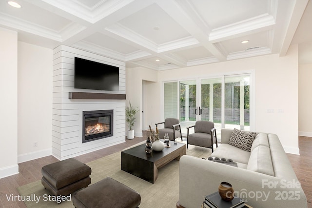 living room with beamed ceiling, a fireplace, coffered ceiling, and wood finished floors