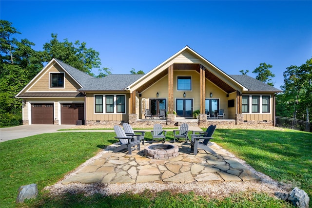 view of front facade with a fire pit, a patio area, and a front yard