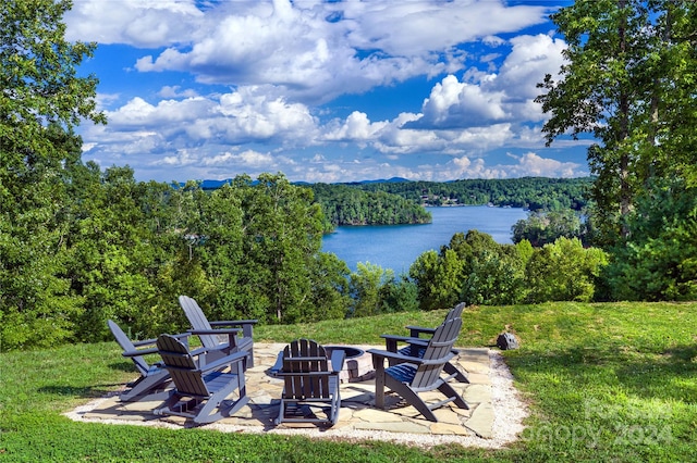 view of patio / terrace with a fire pit and a water view