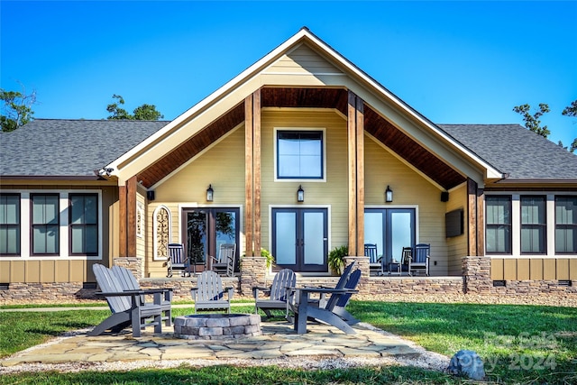 back of property with a patio area and a fire pit