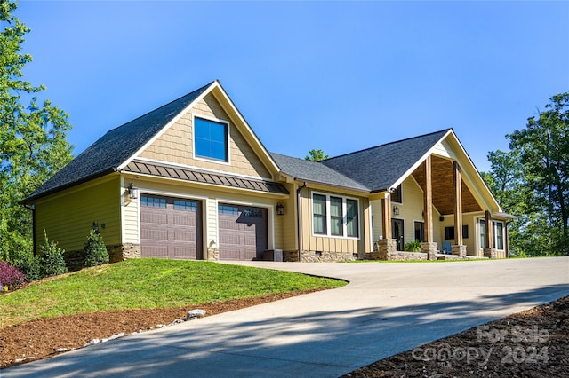 craftsman-style home with a garage and a front lawn