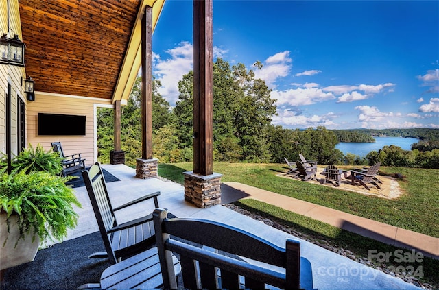 view of patio featuring a fire pit and a water view