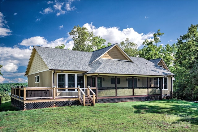 rear view of property featuring a yard and a deck