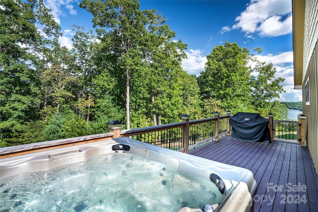 view of pool featuring grilling area and a deck