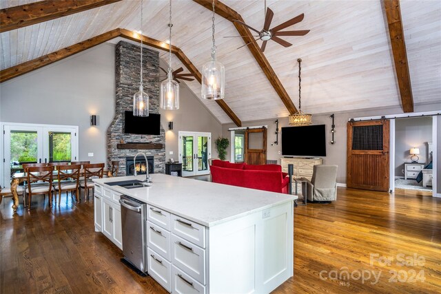 kitchen featuring a fireplace, french doors, ceiling fan, and dark wood-type flooring