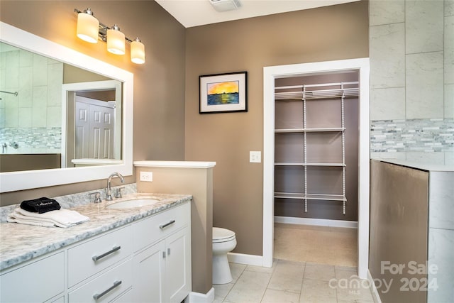 6521 Lake James Rd, Marion, NC 28752 - full bath with tasteful backsplash, toilet, vanity, baseboards, and a walk in closet