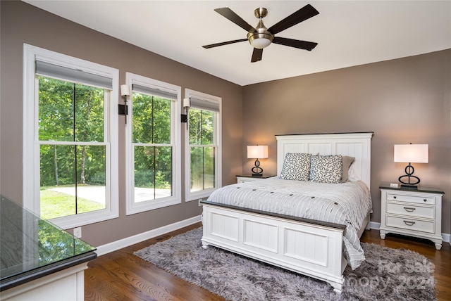 bedroom with multiple windows, ceiling fan, and dark hardwood / wood-style floors