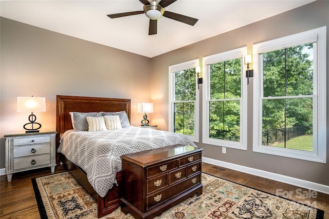 bedroom with ceiling fan and dark hardwood / wood-style floors