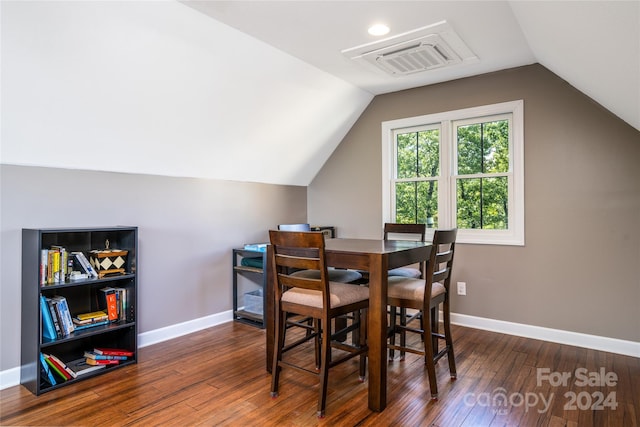 dining area with vaulted ceiling and dark hardwood / wood-style flooring