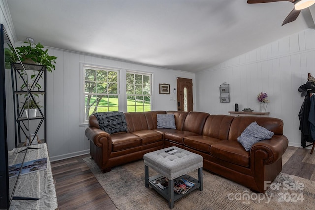 living room featuring ceiling fan, lofted ceiling, and dark wood-type flooring