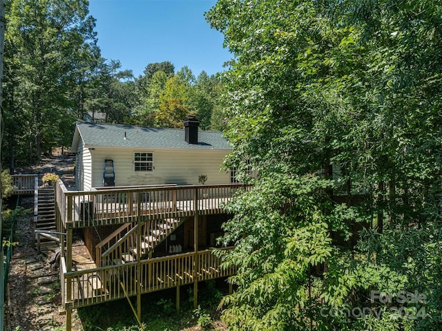 rear view of house featuring a deck