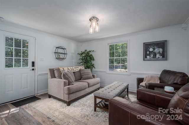 living room with light hardwood / wood-style floors and ornamental molding