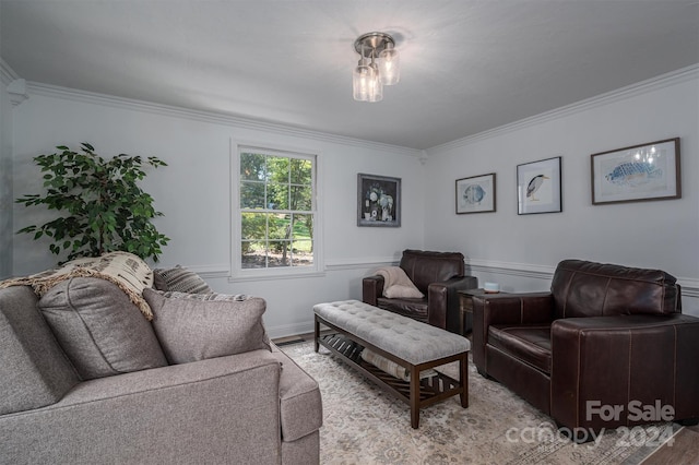 living room with light wood-type flooring and crown molding