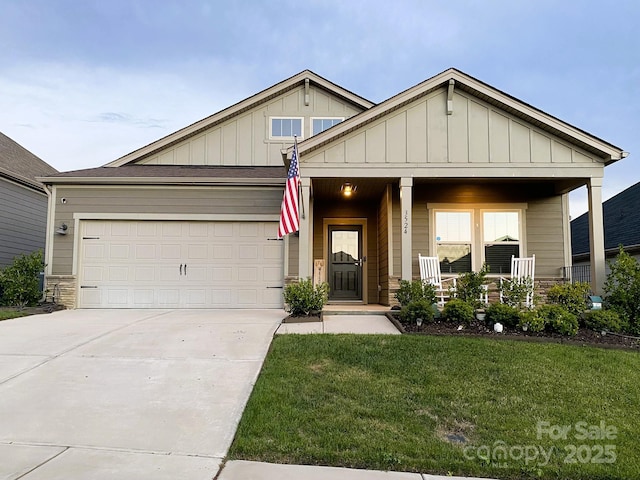 craftsman-style house featuring a garage, concrete driveway, a porch, a front lawn, and board and batten siding