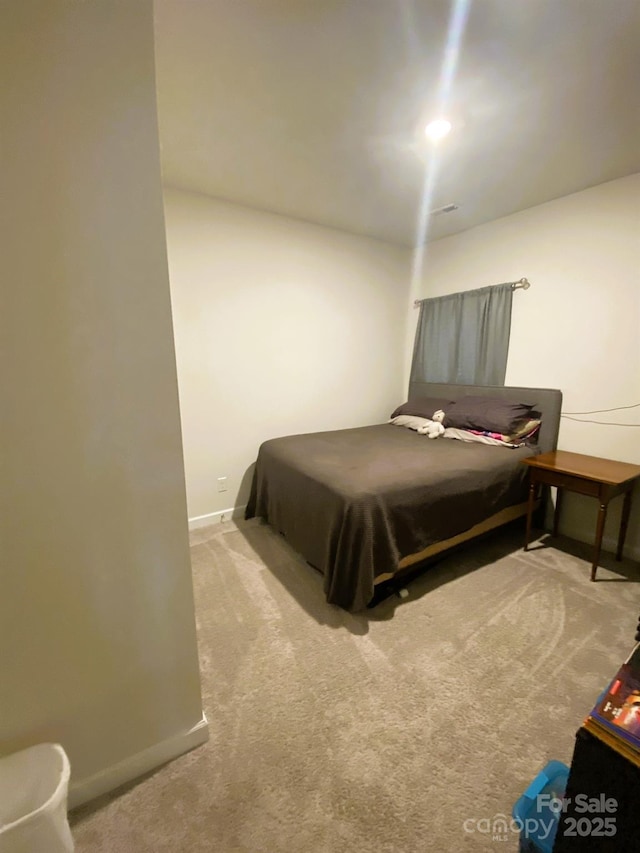 bedroom featuring carpet and baseboards