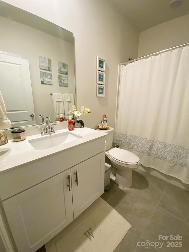 bathroom featuring toilet, tile patterned floors, a shower with shower curtain, and vanity