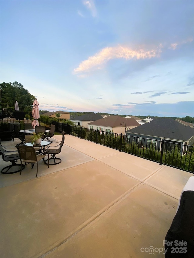 view of patio with outdoor dining area and fence