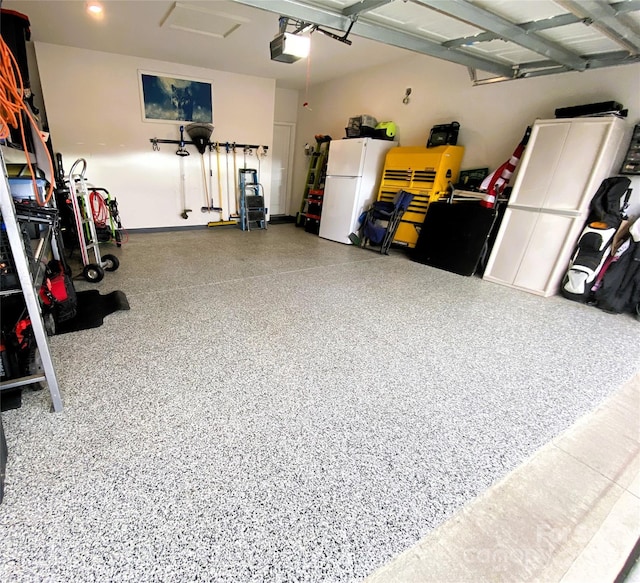 garage with a garage door opener and freestanding refrigerator